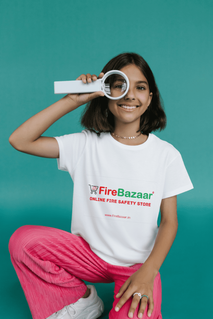 a girl wearing Fire Bazaar's T Shirt with a lens in his hand watching something for Zooming